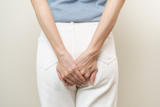 Health care, pain asian young woman suffering from hemorrhoid, anus, diarrhea and constipation, girl hand touching, holds butt, anal have abdominal, intestine problem, abscess disease and smell fart.