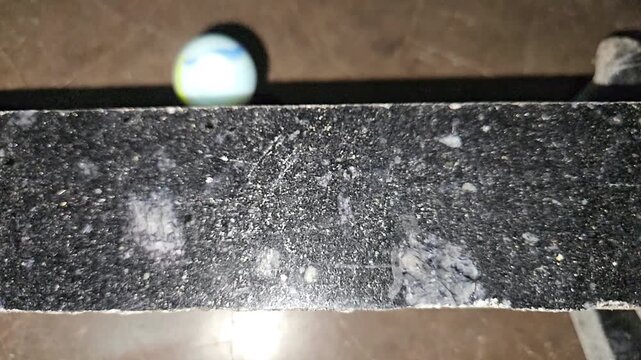 Glass Sphere Rolling Across Black Marble Surface in Slow Motion, Physics, Gravity, Motion, Balance, Minimal Abstract Background, Precision Movement