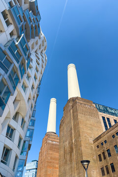 London, UK - 19 June 2026: The redeveloped Battersea Power Station complex, with the iconic twin white chimneys and luxury apartments of Prospect Place. Summer blue sky background.