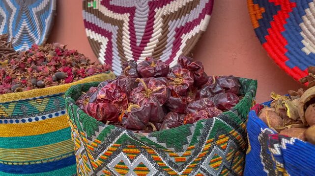 Close up overview across lots of vibrant colorful herb and spice powders in street market. Different spices displayed for sell.