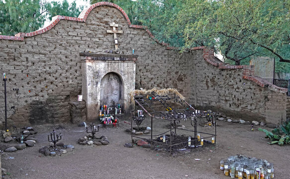 The local shrine of El Tiradito, the little lost one, in the old barrio of Tucson, Arizona where community members mourn otherwise forgotten people with candles, flowers and messages put into the wall