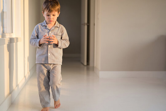 Boy in Pajamas Buttoning Shirt at Home Morning Getting Dressed