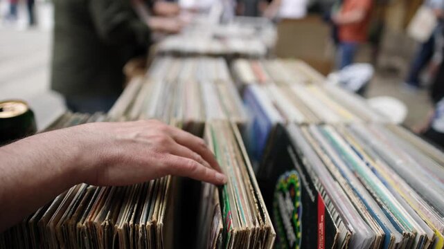 Trending Person Choosing Vinyl Record Outdoor Shop Market Music Collection Close Up in 4K Ultra HD footage.

