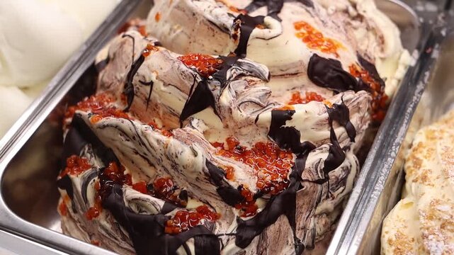 Supermarket ice cream shelf with various flavors and brands, retail food concept.
