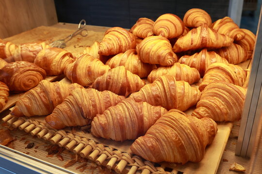 Fresh butter croissants displayed in bakery shop. Ready to buy and eat for breakfast with coffee. 