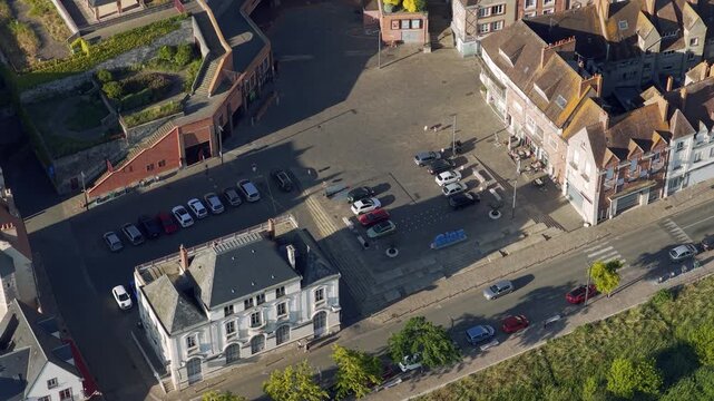 Aerial footage showcasing the historic town center of Gien, France. The video captures traditional French architecture, a prominent church, and surrounding residential neighborhoods, with lush
