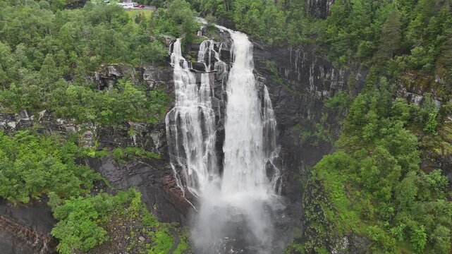 Aerial drone static shot of Skjervsfossen with mountain background, Norway