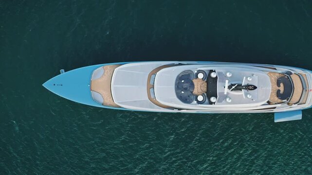 Luxury mega yacht cruising on calm turquoise ocean water off the coast of Ko Samui, offering an exclusive experience for travel, vacation, and escape to a tropical paradise. Top down aerial drone shot