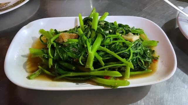 Authentic Thai Style Morning Glory Stir Fry Dish Cuisine (Pak Boong) with Pork. Healthy Street Food in Bangkok Thailand Restaurant