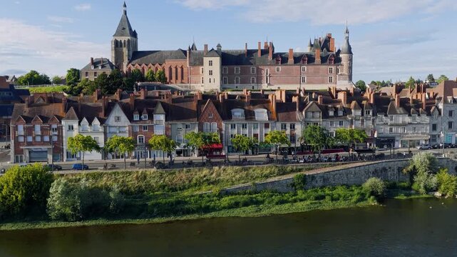 Aerial footage showcasing the historic Chateau de Gien and the surrounding old town in Gien, France. The video captures the impressive castle, traditional French architecture with red-tiled roofs