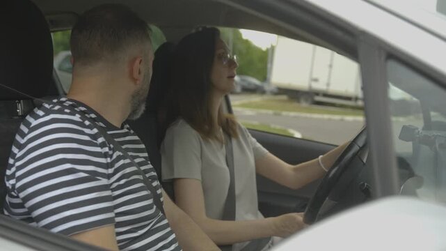 Husband giving driving lessons to his wife
