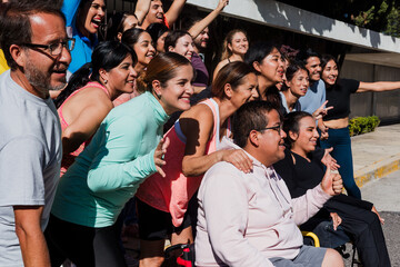 Obraz premium Group of latin people running and training together in mexican street in Mexico Latin America, hispanic runners club preparing a race