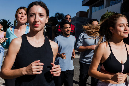 Group of latin people running and training together in mexican street in Mexico Latin America, hispanic runners club preparing a race