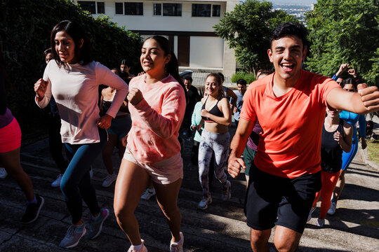Group of latin people running and training together in mexican street in Mexico Latin America, hispanic runners club preparing a race
