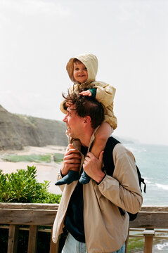 Traveling Dad Carries Toddler Along Portugal's Ocean Cliffs on Film