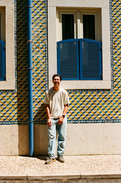 Man traveling in Lisbon, Portugal by tiled wall  film photo