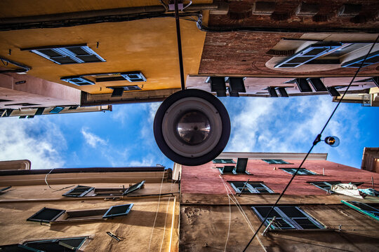 Low angle view of narrow Caruggi alley in Genoa historic center, Italy