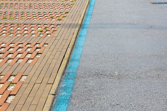 CONCRETE FLOORING BLOCKS IN A PUBLIC PARKING LOT permeable to rain water as required by the building laws used for sidewalks and parking areas - Permeable interlocking concrete pavers - PICP