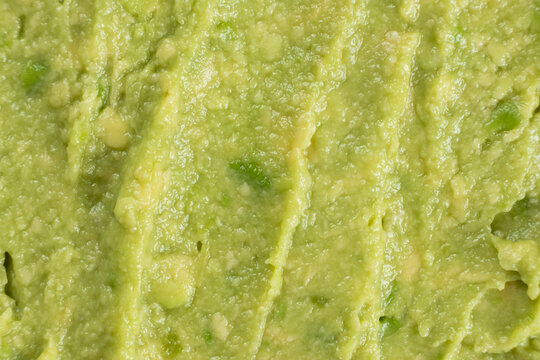 Abstract food background of fresh mashed avocado texture