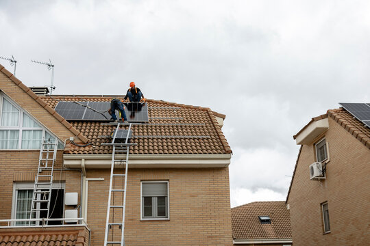 Installing solar panels on residential roof connecting new energy