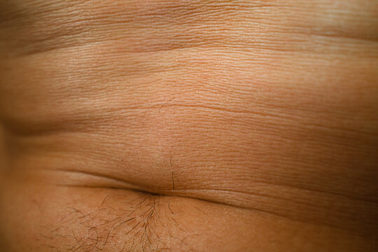 Tanned Skin Texture Of A Male Body Part In Sunlight Close-Up