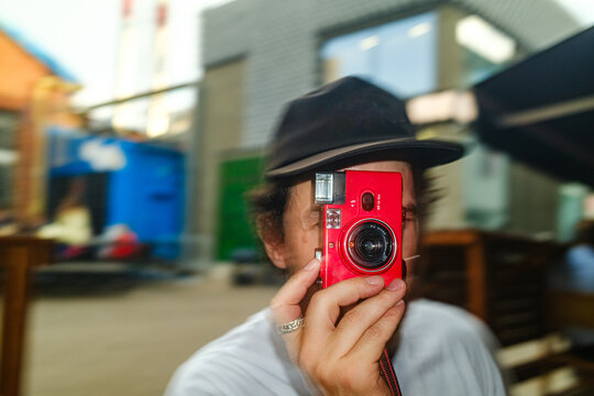 Person Takes A Photo With Film Camera