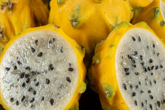Cut ripe yellow pitahaya fruits close up view.