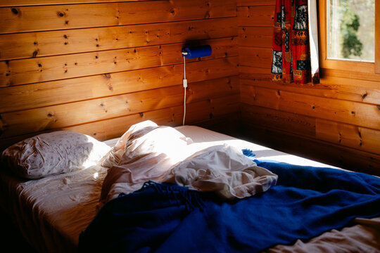 unmade bed in cabin
