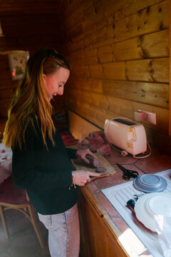 Young woman cutting saucisson ( salami) in France