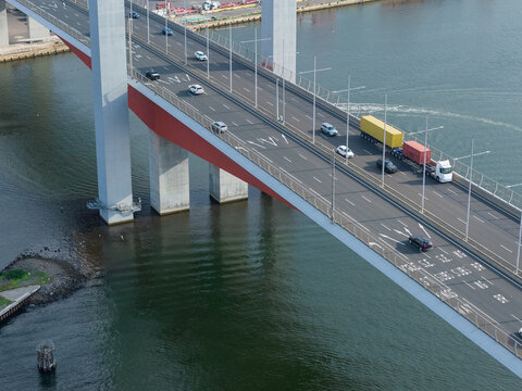 Traffic on a multi-lane frewway bridge over a wide river