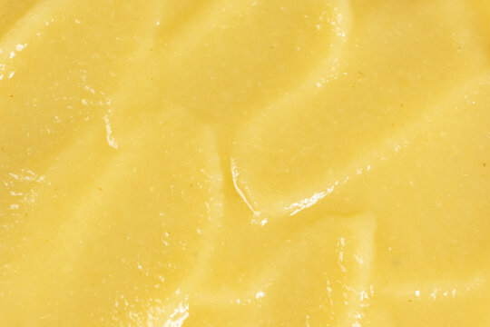 Macro texture of smooth organic apple puree top view.
