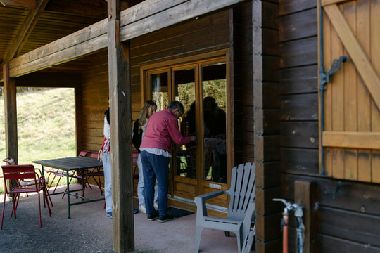 woman entering chalet 