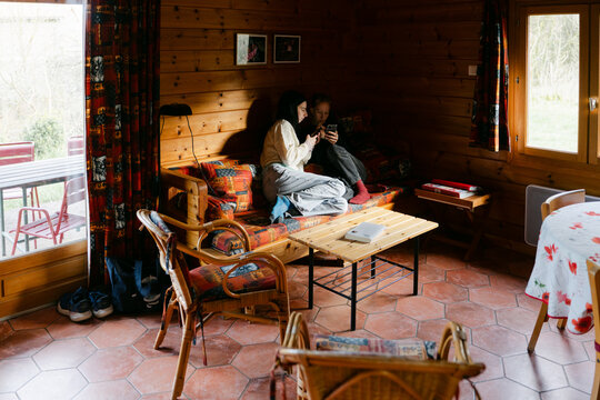 young women inside vacation rental, a chalet. 