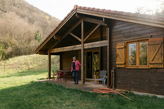 woman walking into chalet in the spring