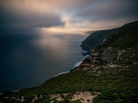 Aerial view of the rugged cliffs at Sharp Point Lookout with dramatic clouds over the Southern Ocean in Torndirrup, Western Australia, Australia.