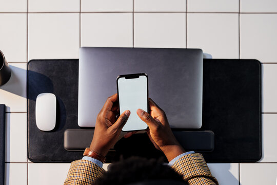 Man Using Smartphone at Desk 
