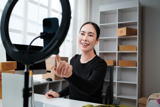 Asian woman live streaming selling products online