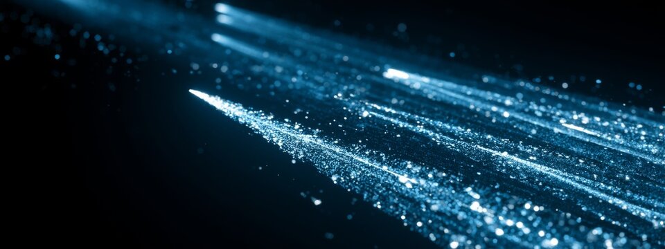 Dynamic particles of light forming trails while accelerating, creating a mesmerizing visual effect against a dark background