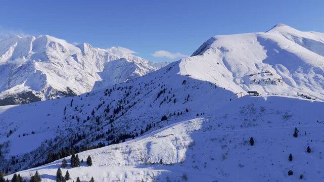 Stunning panoramic aerial footage of the snow-covered Mont Blanc massif and surrounding alpine slopes in winter, filmed in the Sallanches and Passy valley region near Mont Joly and Megeve, French
