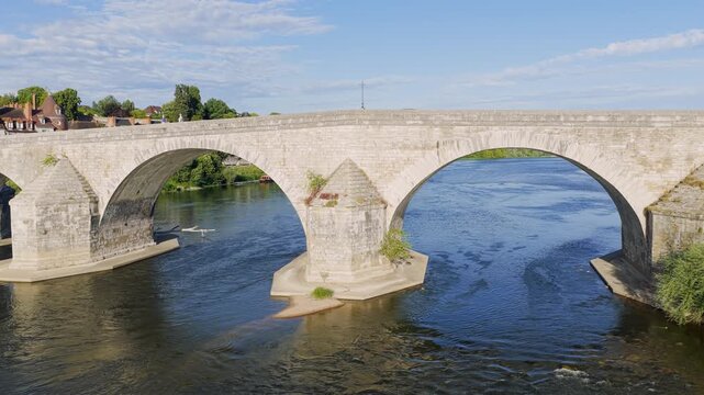 A daylight scene featuring the iconic stone bridge of Gien spanning the Loire River in central France. The video captures the bridge s classic arches, flowing river water, and the picturesque