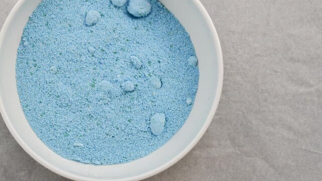 Close-up of laundry detergent, granular texture revealing effectiveness. Perfect for cleaning and hygiene projects.