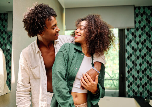 Portrait of a lovely young couple together, bonding hugging and relaxing at home