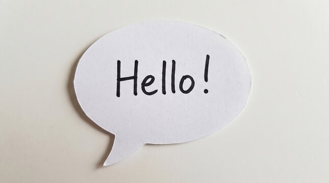 Handwritten Hello greeting on paper speech bubble, minimalist message bubble on white background, friendly communication and welcome concept