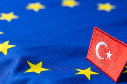 Turkish patch on a blurred European Union flag background representing geopolitical relations