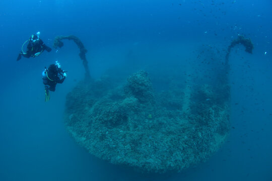 Scuba divers explore the varese wreck site in the waters near pula city, croatia