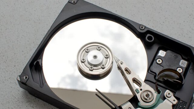 Close-up of a computer HD on a minimalist surface, ready to enhance its capabilities. Computer HDD, symbol of advanced storage, standing out on a simple and functional surface.