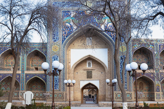 Nadir Divan Begi Madrasah portal with elaborate mosaic tilework and pointed arch in Bukhara, Uzbekistan. Ideal for travel publications, cultural heritage content, and architectural features.