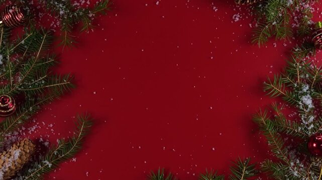 Evergreen pine branches with sparkling ornaments and snow creating a festive holiday motion video clip