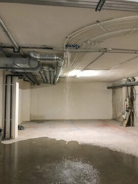 Water leaking from building ceiling causing flood damage