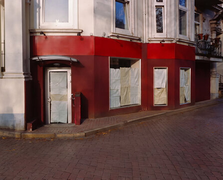 Closed Corner Store in Quiet Residential Neighborhood with Paper Covered Windows